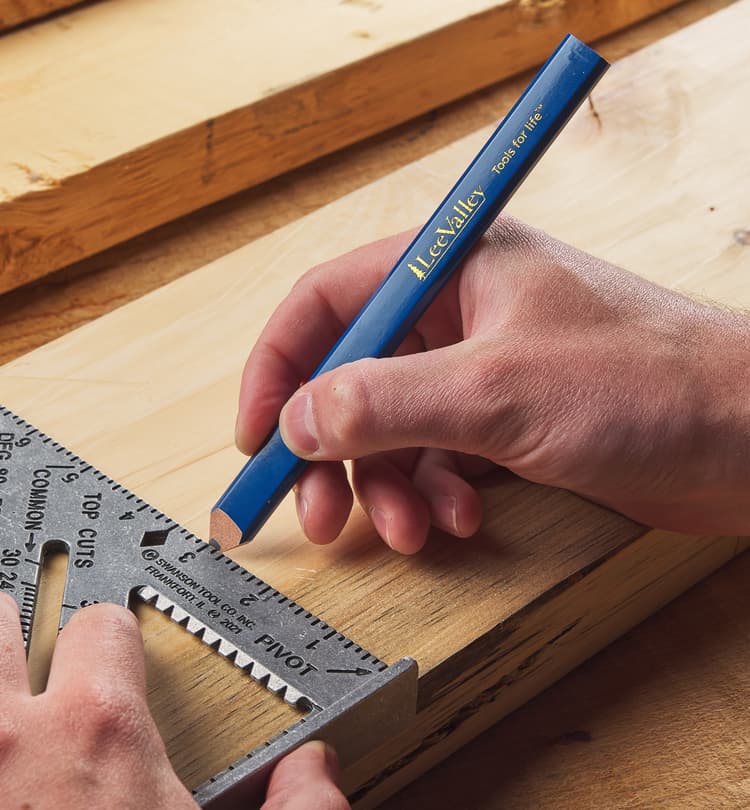 Woodworker measuring and marking